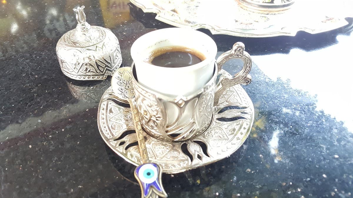 A cup of Turkish coffee at Cleopatra, served in a patterned cup with a saucer